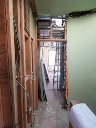 Interior hallway under construction with exposed framing and materials.