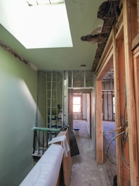 Interior hallway under renovation with exposed framing.