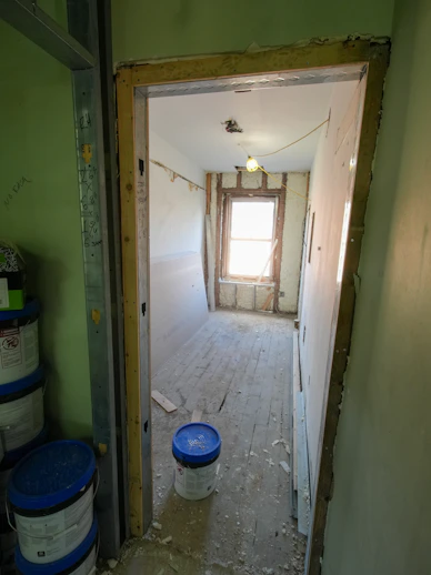 Interior room under renovation with drywall and window