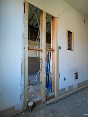 Interior view of unfinished room with exposed wiring.