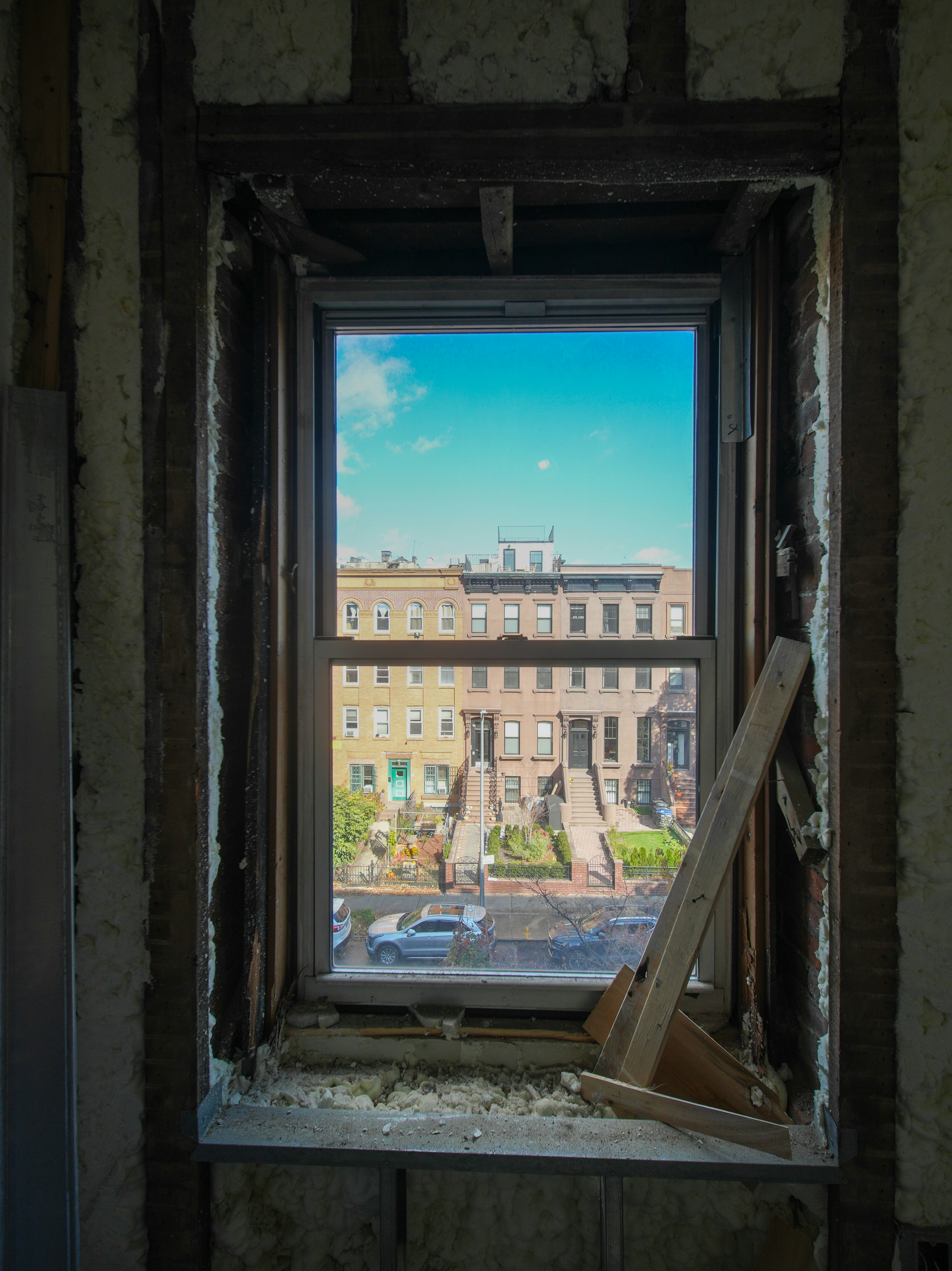 View of city buildings through a window frame