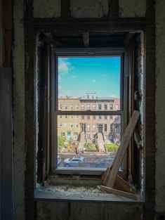 View of city buildings through a window frame