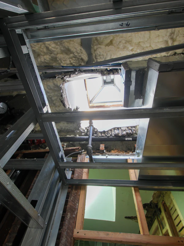 Insulation and Drywall Sequence: Metal framing in ceiling with insulation and skylight opening.