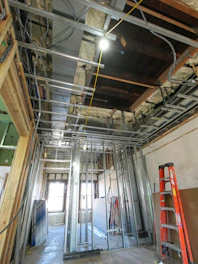 Interior construction with exposed framing and wiring