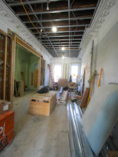 Interior renovation of a room with exposed ceiling and materials.