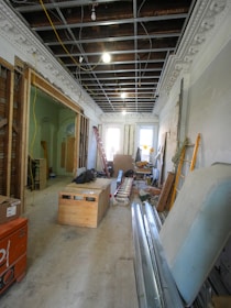 Interior renovation of a room with exposed ceiling and materials.