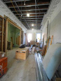 Interior renovation of a room with exposed ceiling and materials.