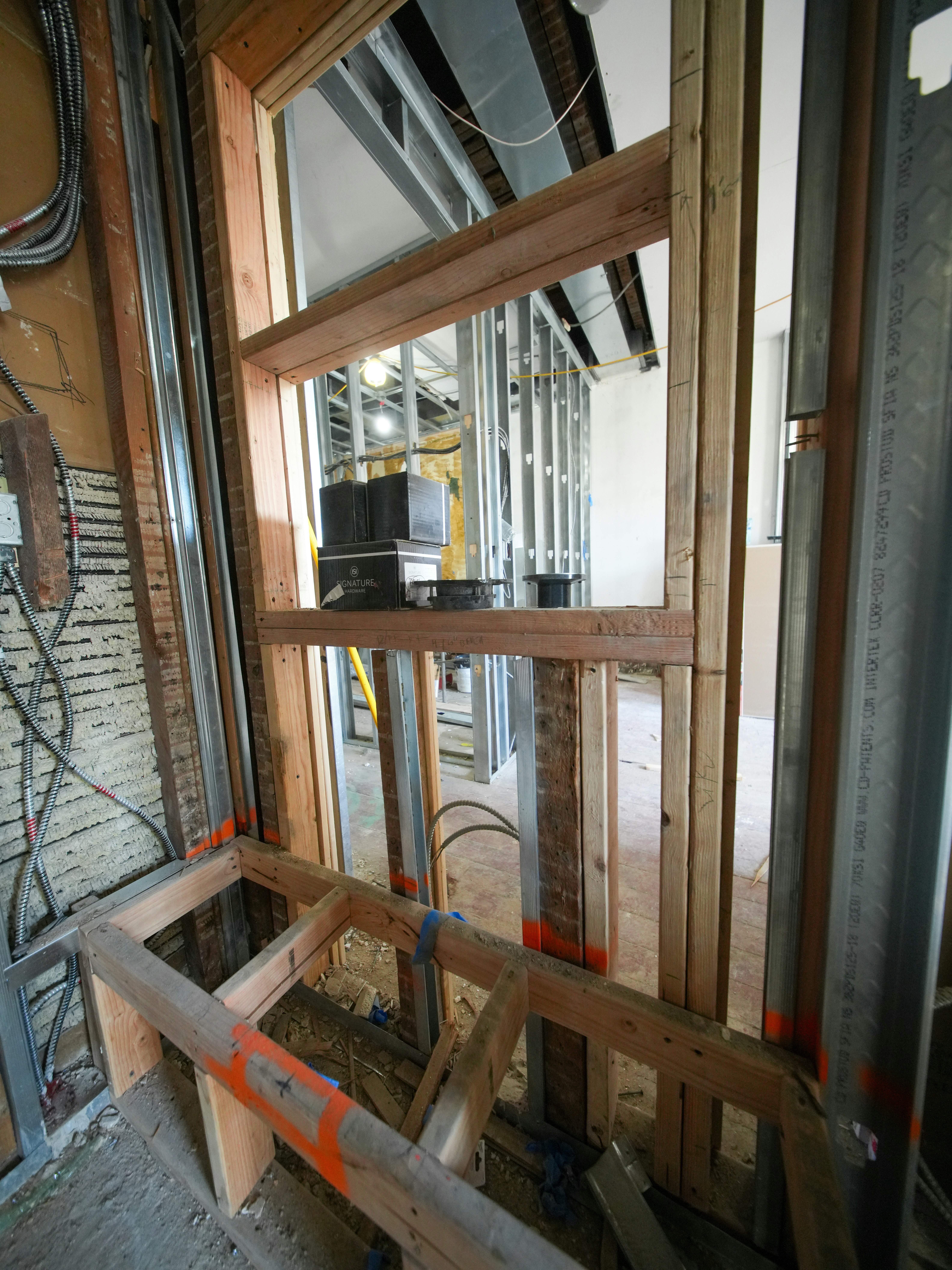 Interior view of a room under construction with wooden framing.