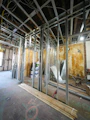 Interior construction with metal studs and exposed ceiling.