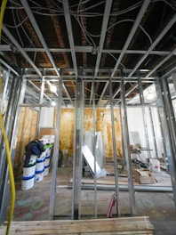 Interior construction with metal studs and exposed ceiling.