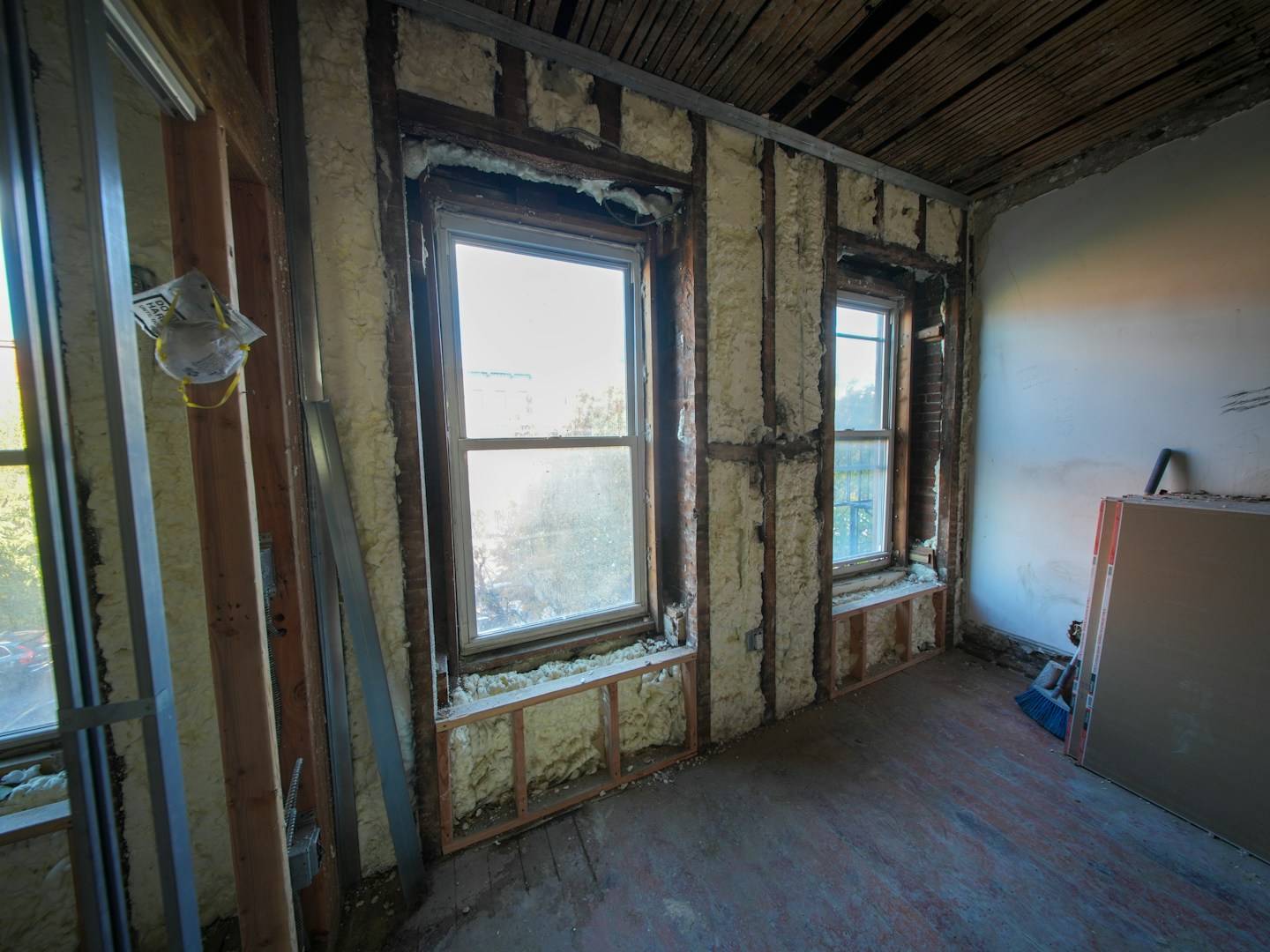 Room under construction with exposed insulation — water damage restoration process
