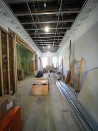 Interior hallway under construction with exposed ceiling and materials.