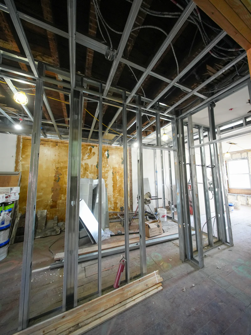 Technician installing new wiring during home construction