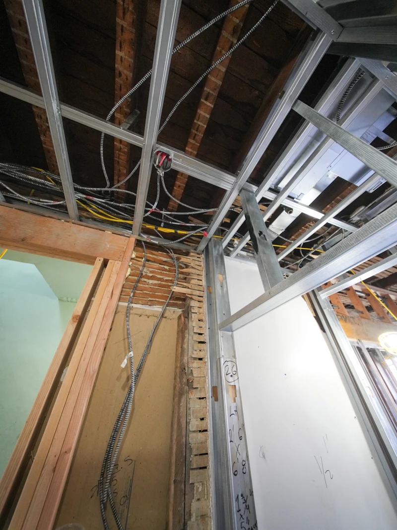 New copper Romex rough-in run through the ceiling of the rewired home