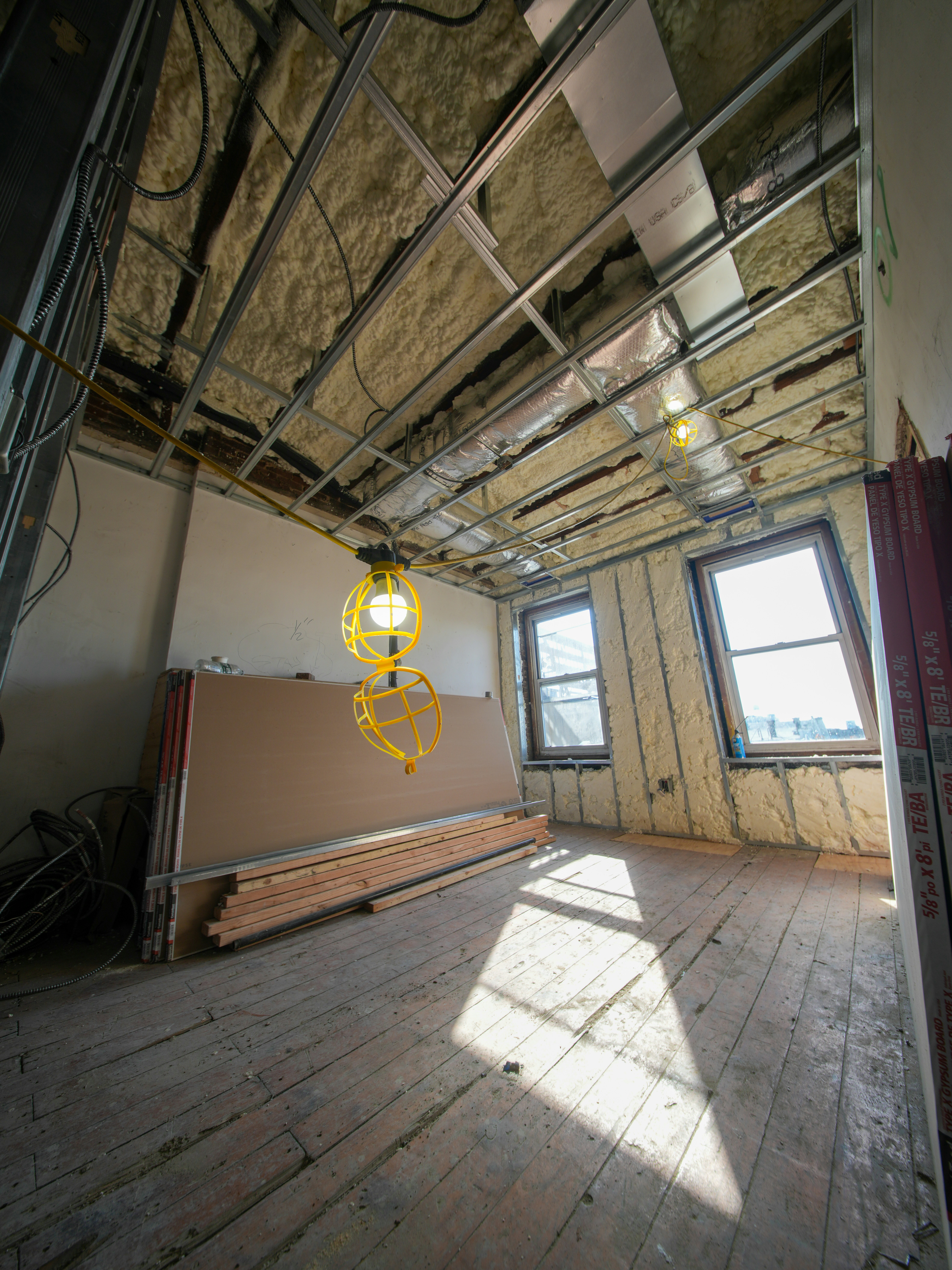 Room under construction with exposed ceiling and insulation