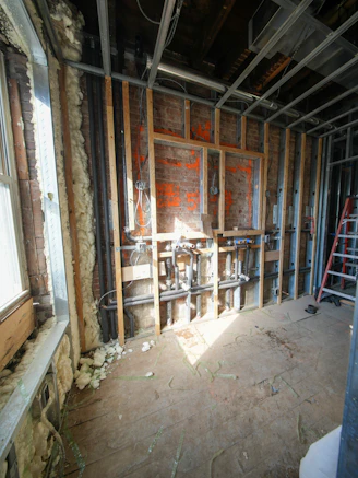Interior construction with exposed pipes and framing