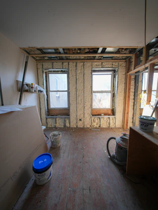 Room under construction with exposed walls and windows