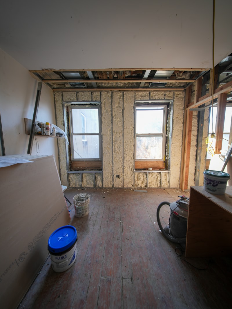 Multi-storey building interior showing exposed framing before insulation