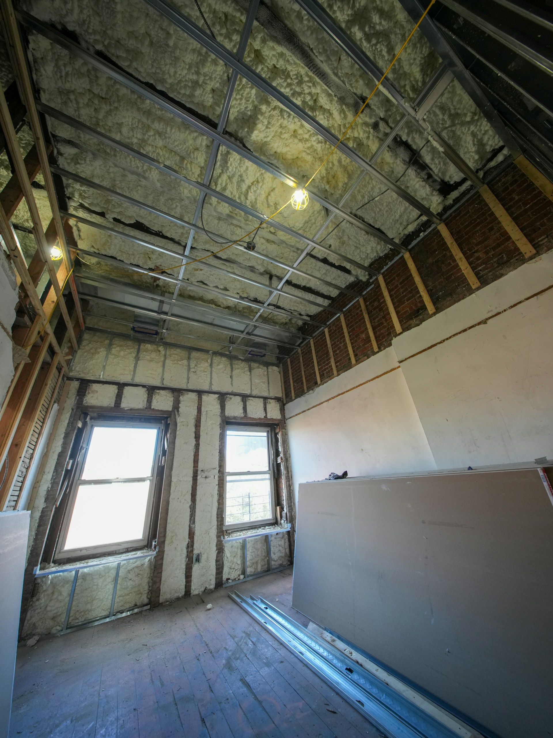 Attic room under construction with exposed framing and insulation.