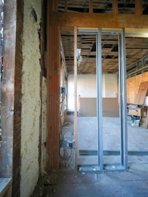 Interior construction with exposed framing and insulation.