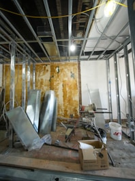 Interior construction site with metal framing and materials.