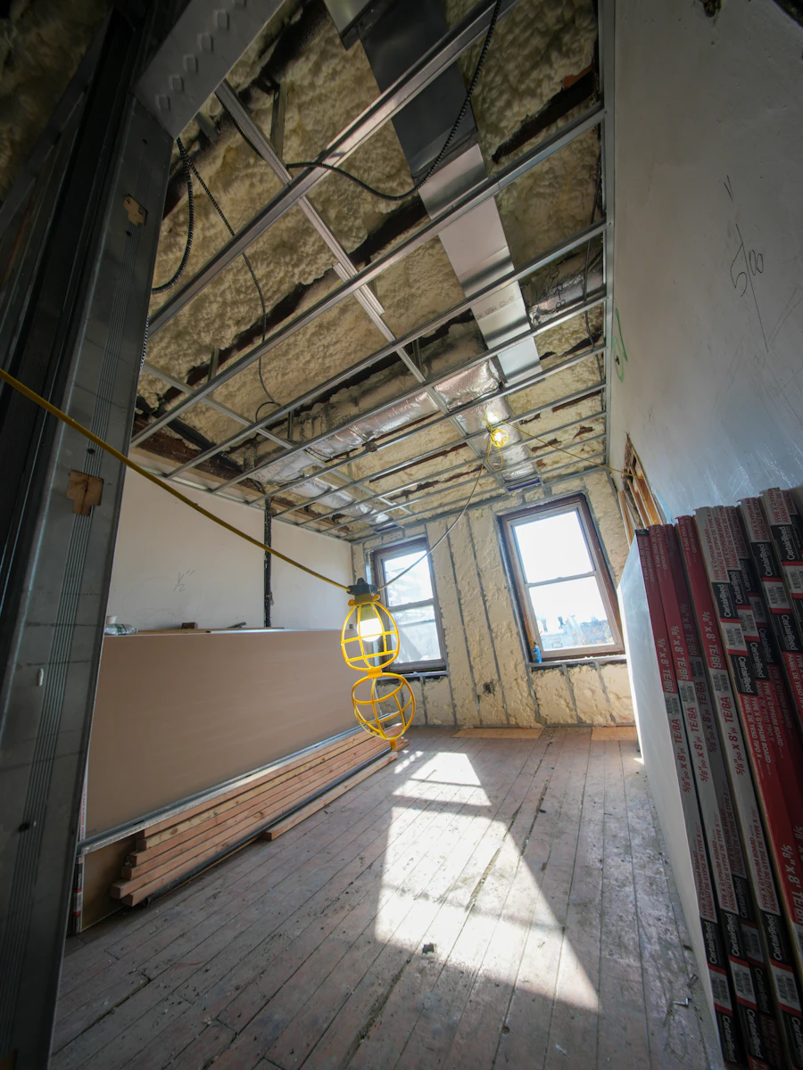Interior renovation with exposed ceiling framing and drywall sheets