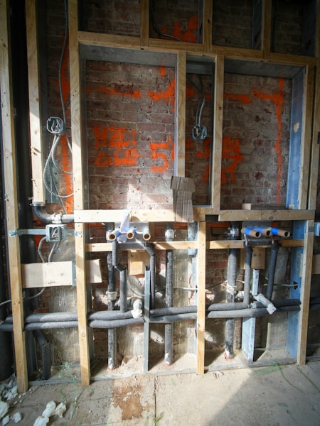 Plumbing and electrical work inside a wall under construction
