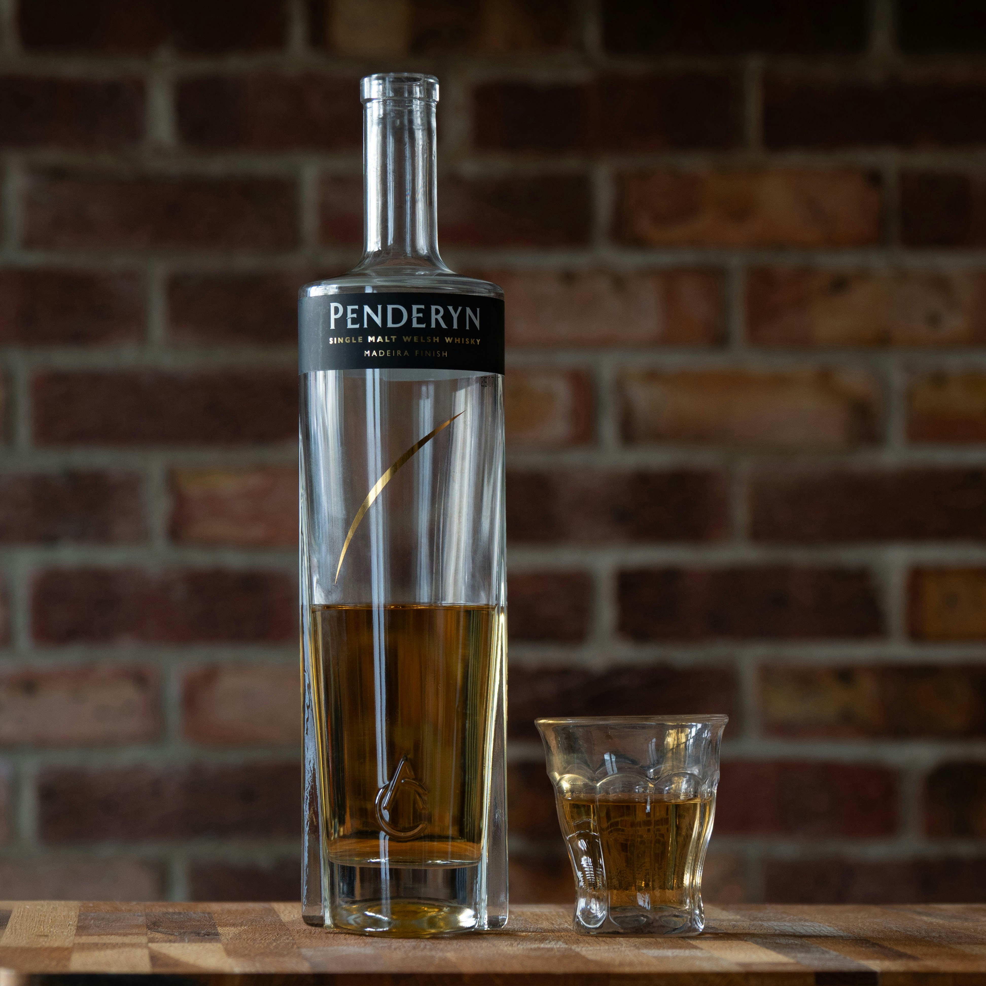 Penderyn whisky bottle and glass on table