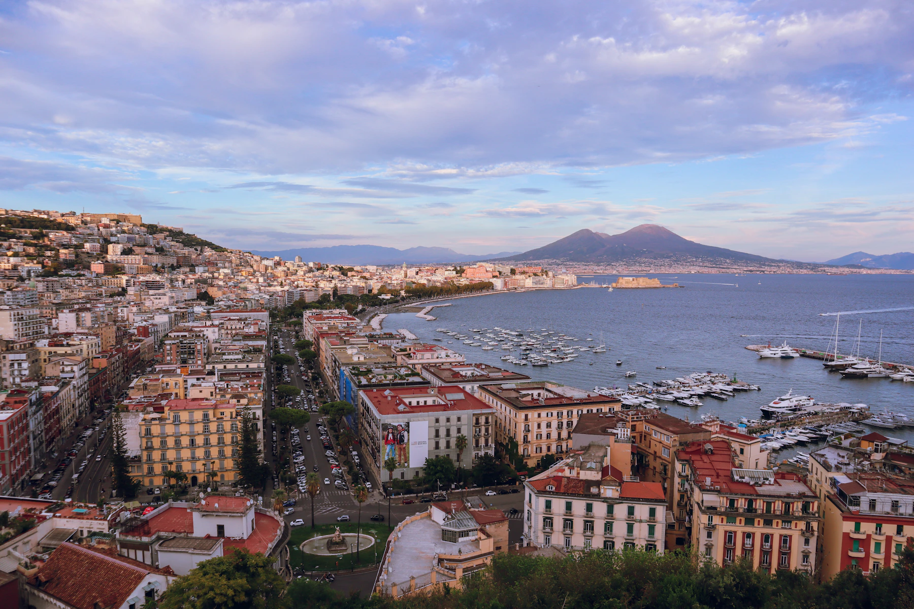 Naples gathered around its bay with Vesuvius rising beyond the city and marina