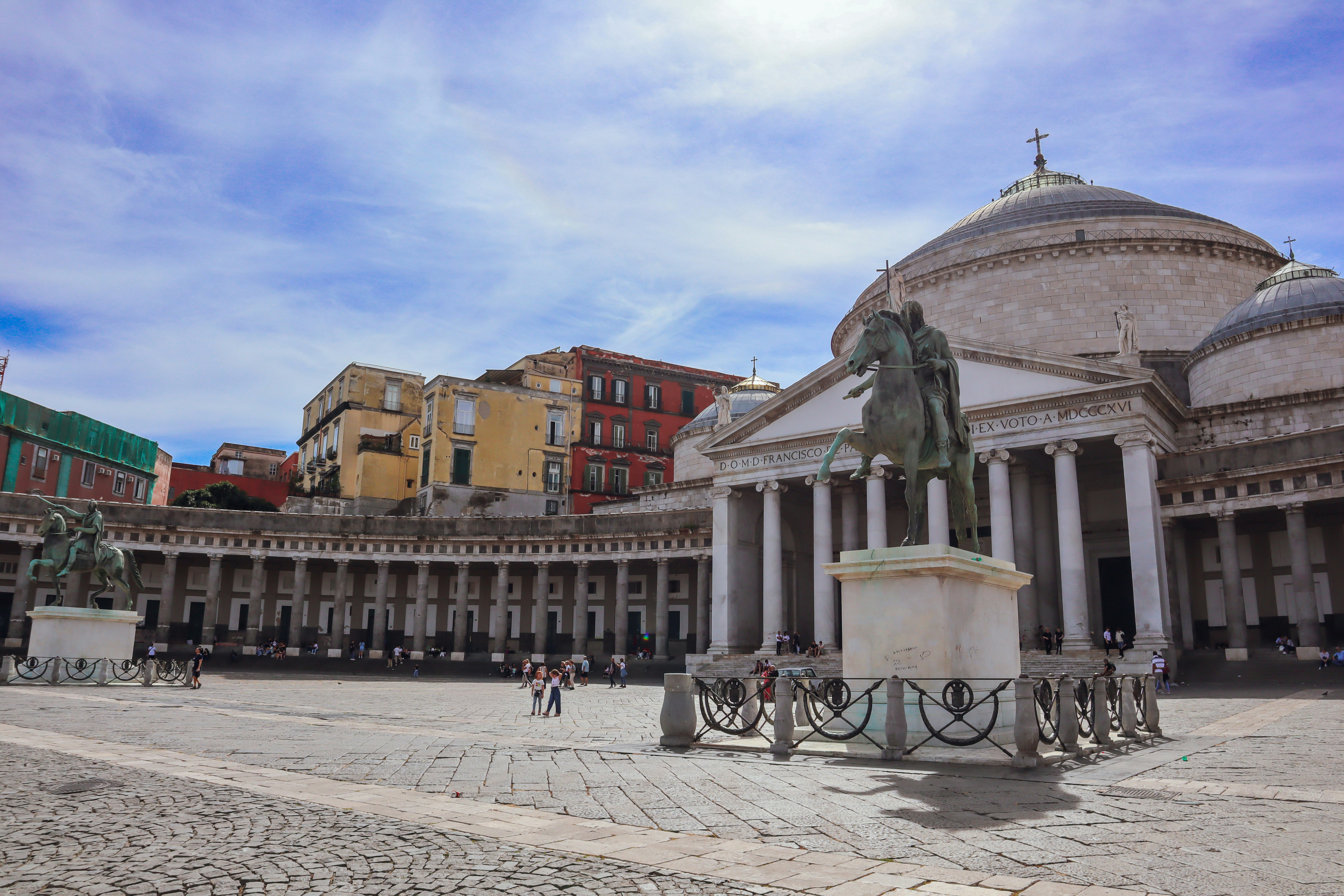 Piazza del plebiscito in naples with royal palace and statue.