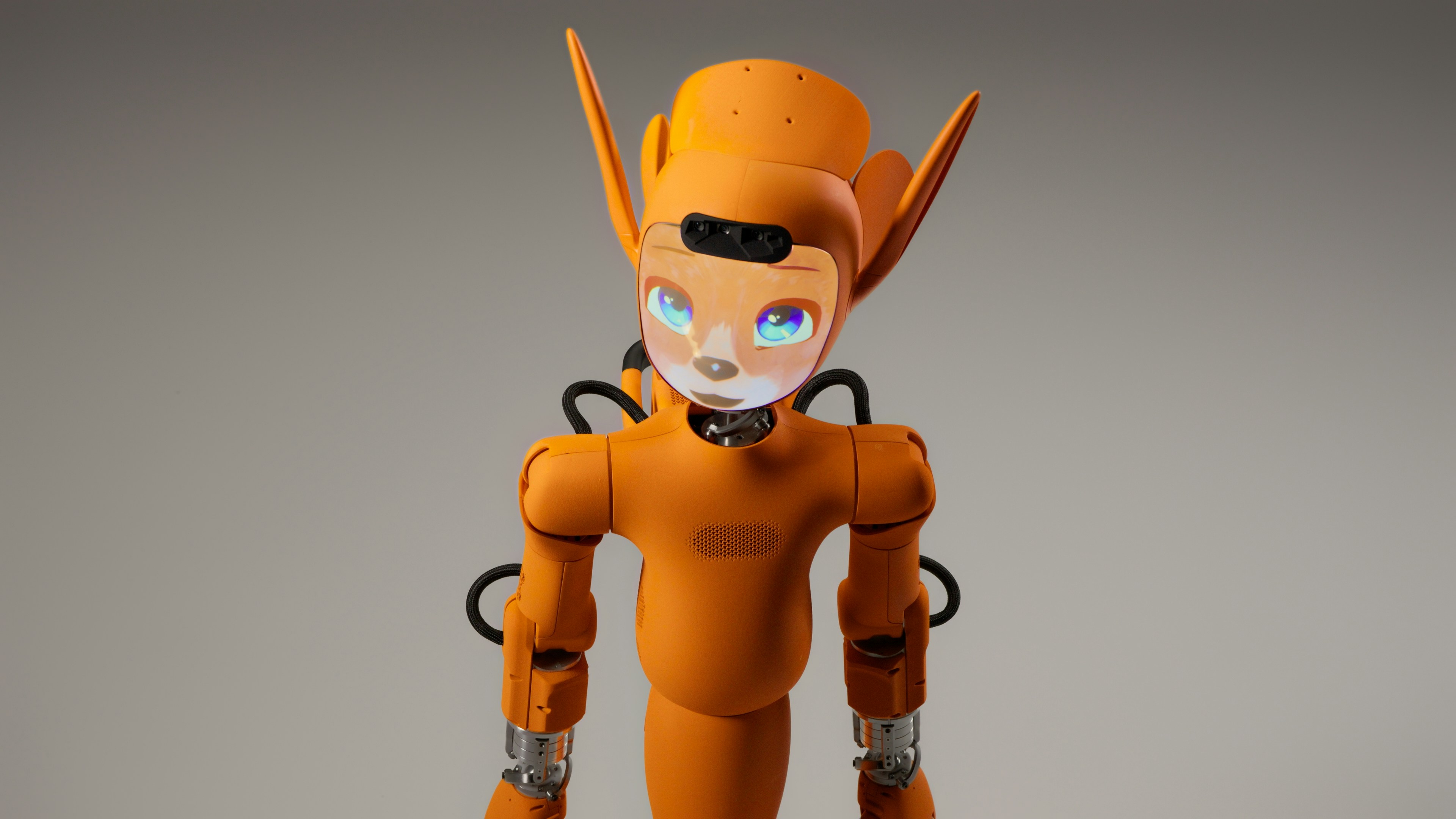 An orange robot with large ears and glowing eyes.