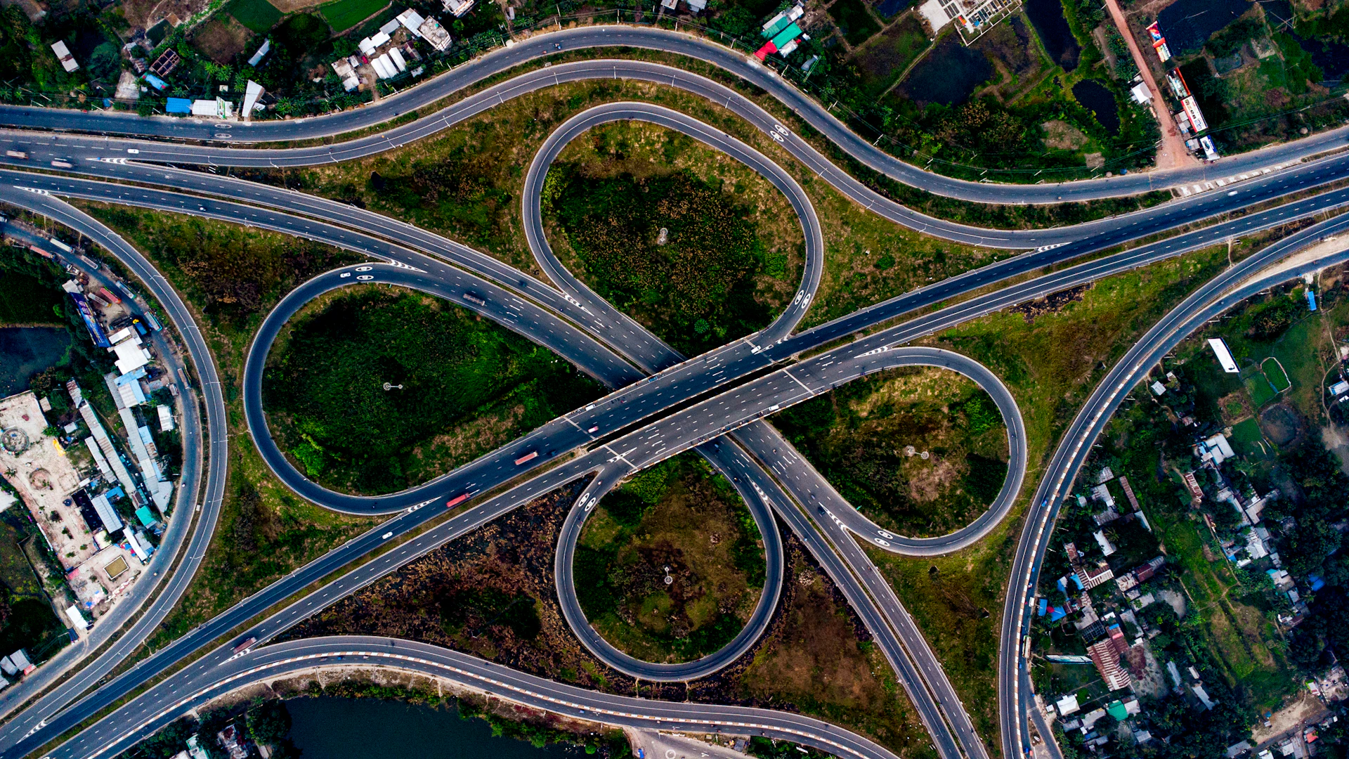 Aerial view of a complex highway interchange with cloverleaf interchanges.