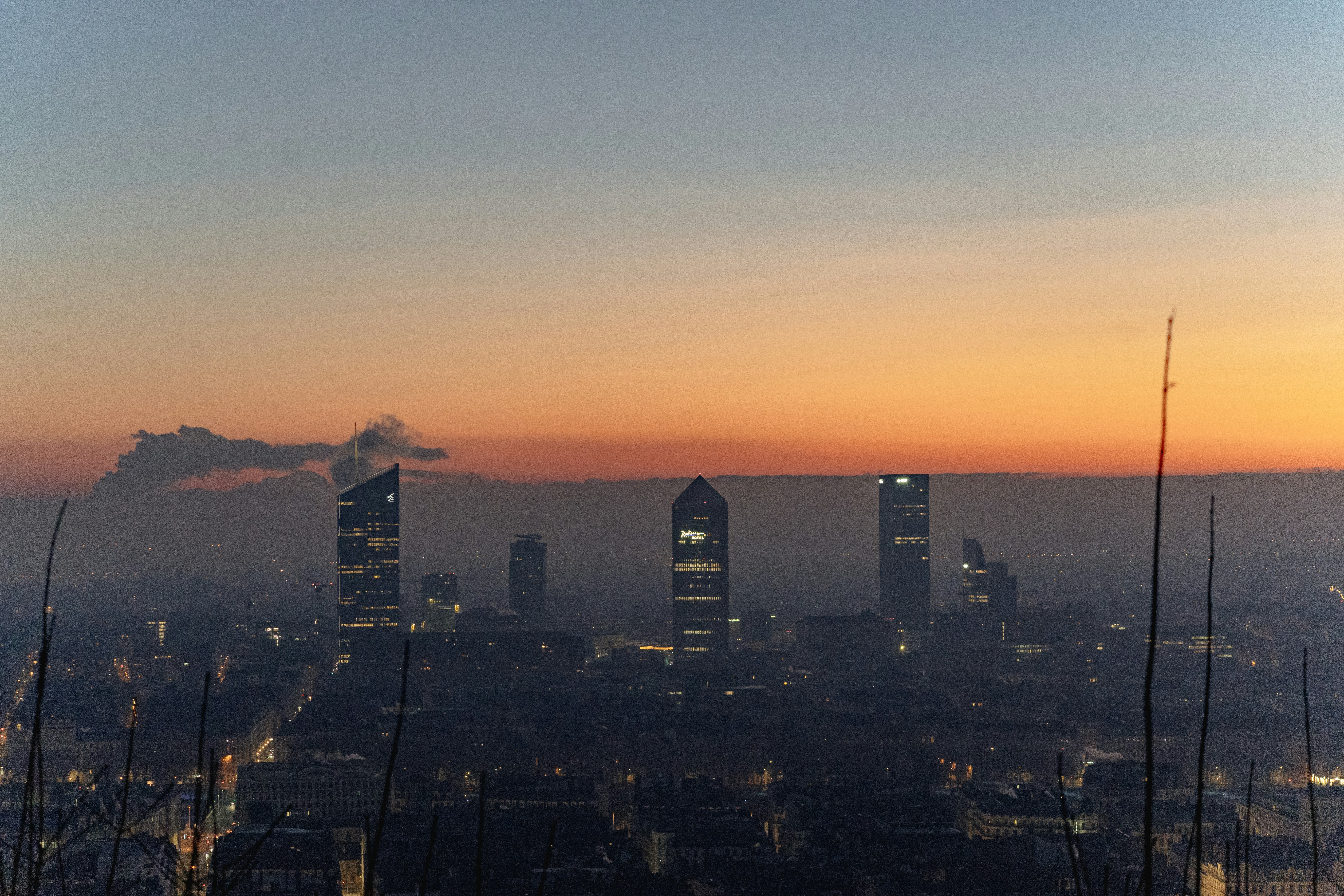 City skyline with modern skyscrapers at sunrise.