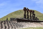 Moai statues with red topknots on easter island.