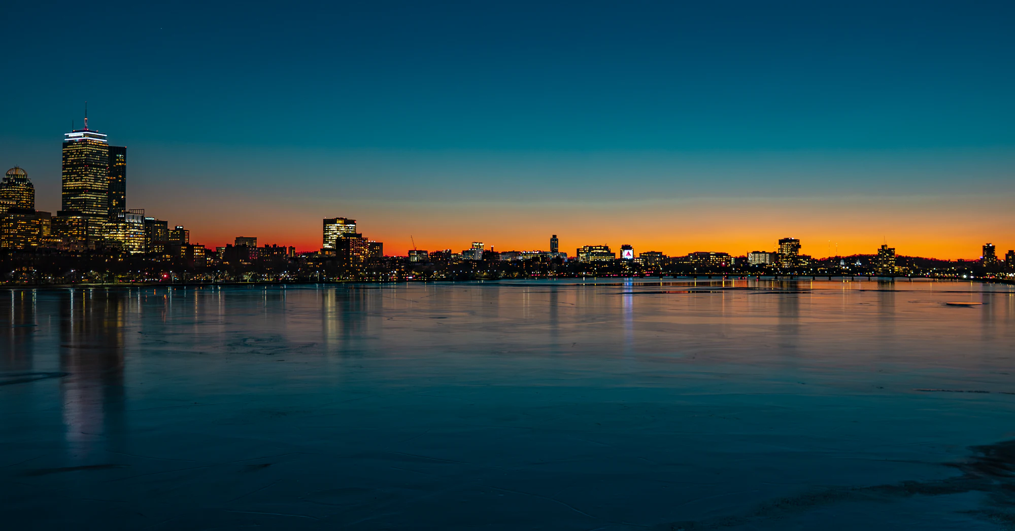 Boston skyline at dusk over the water