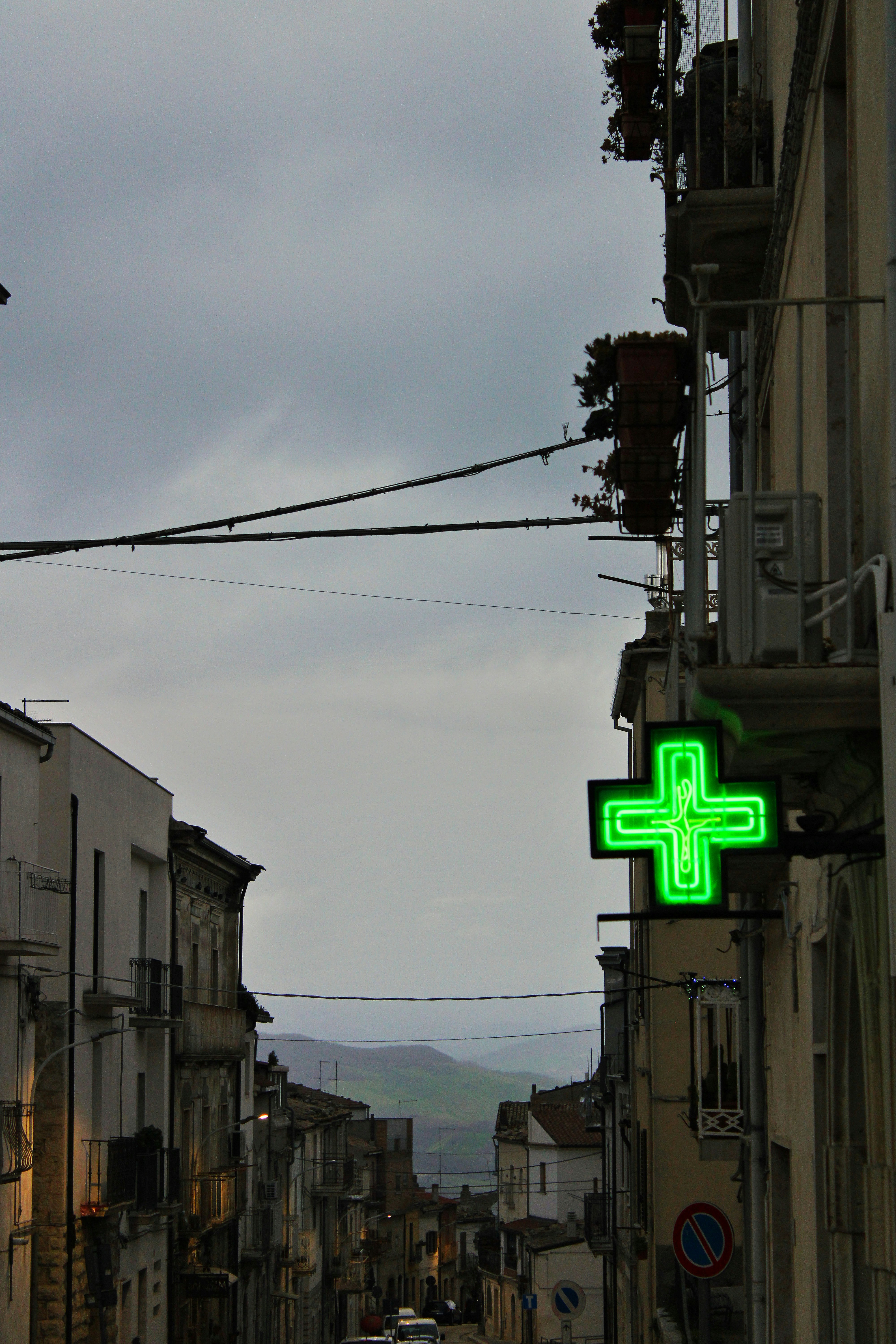 Green pharmacy sign on a street