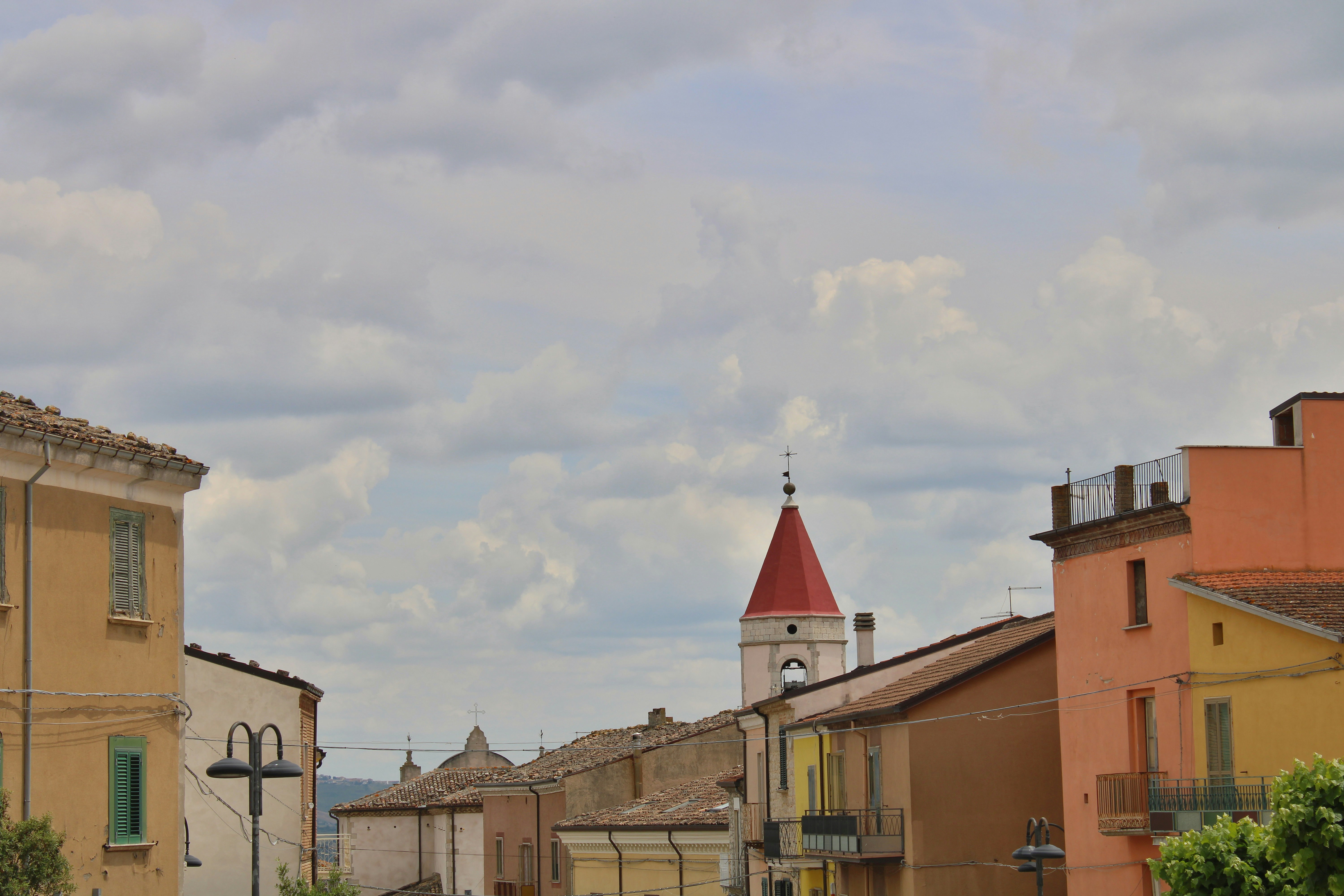 Colorful buildings with a red-roofed church spire.