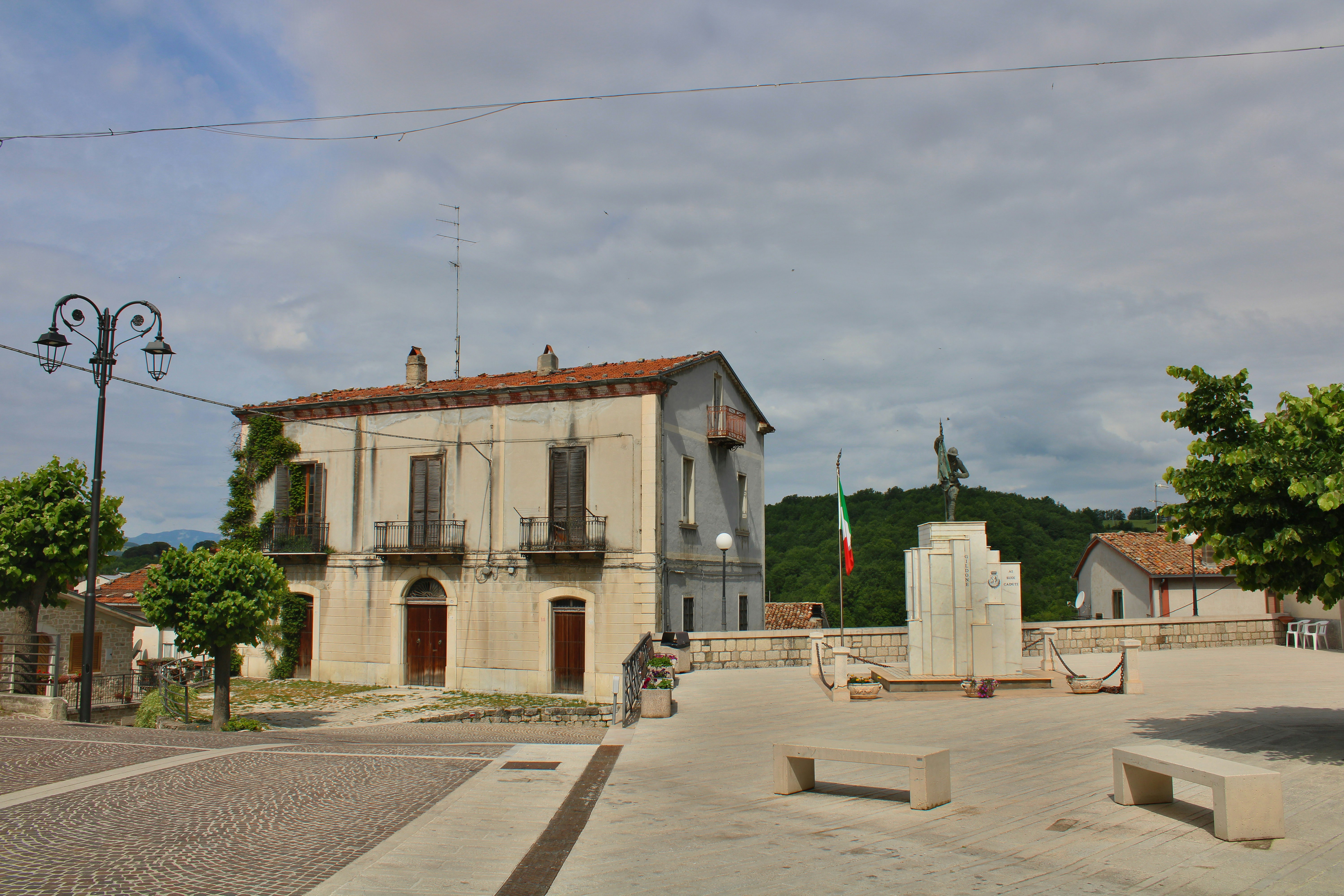 Town square with building, statue, and benches