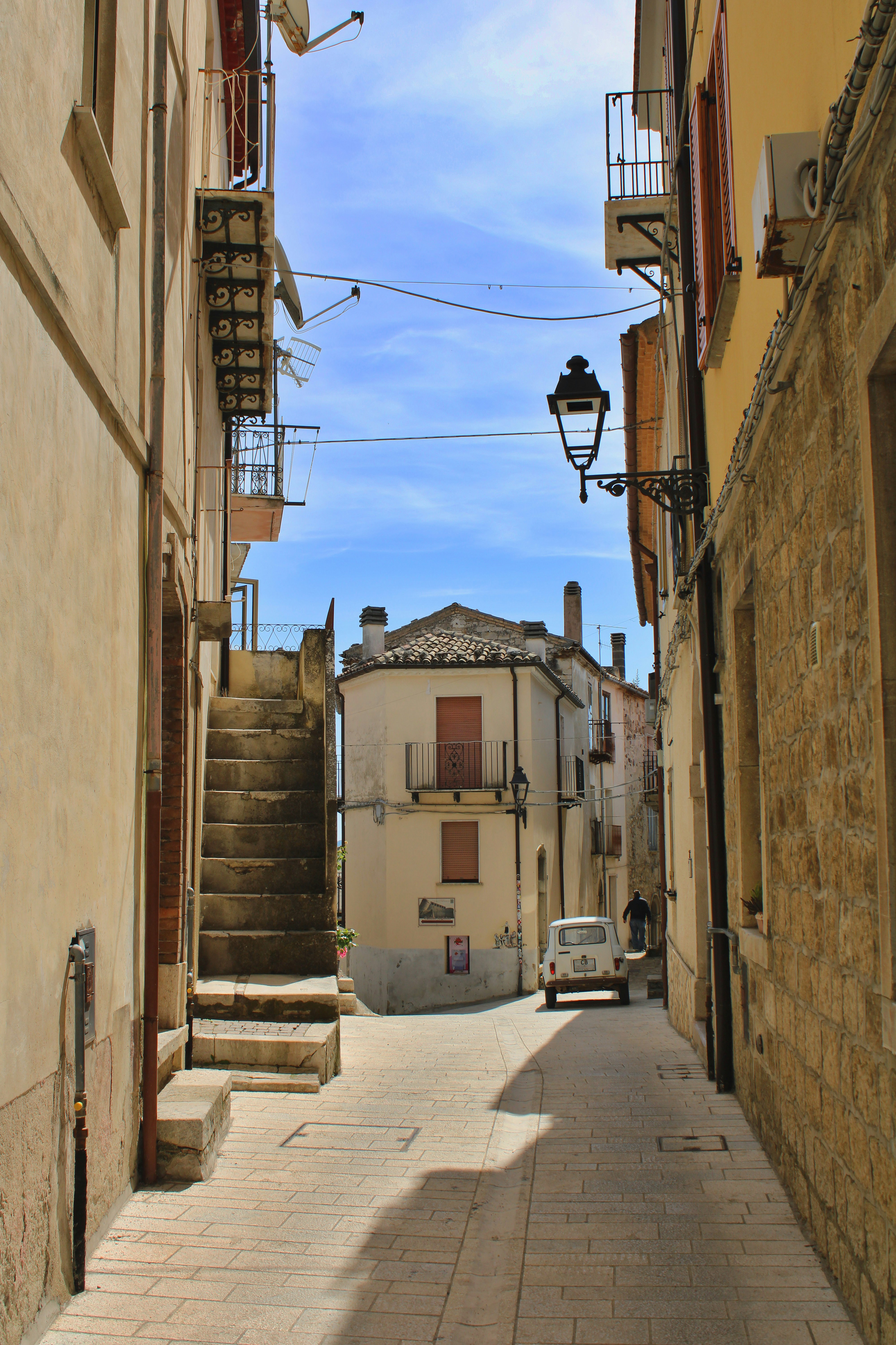 Narrow european street with stone buildings and stairs