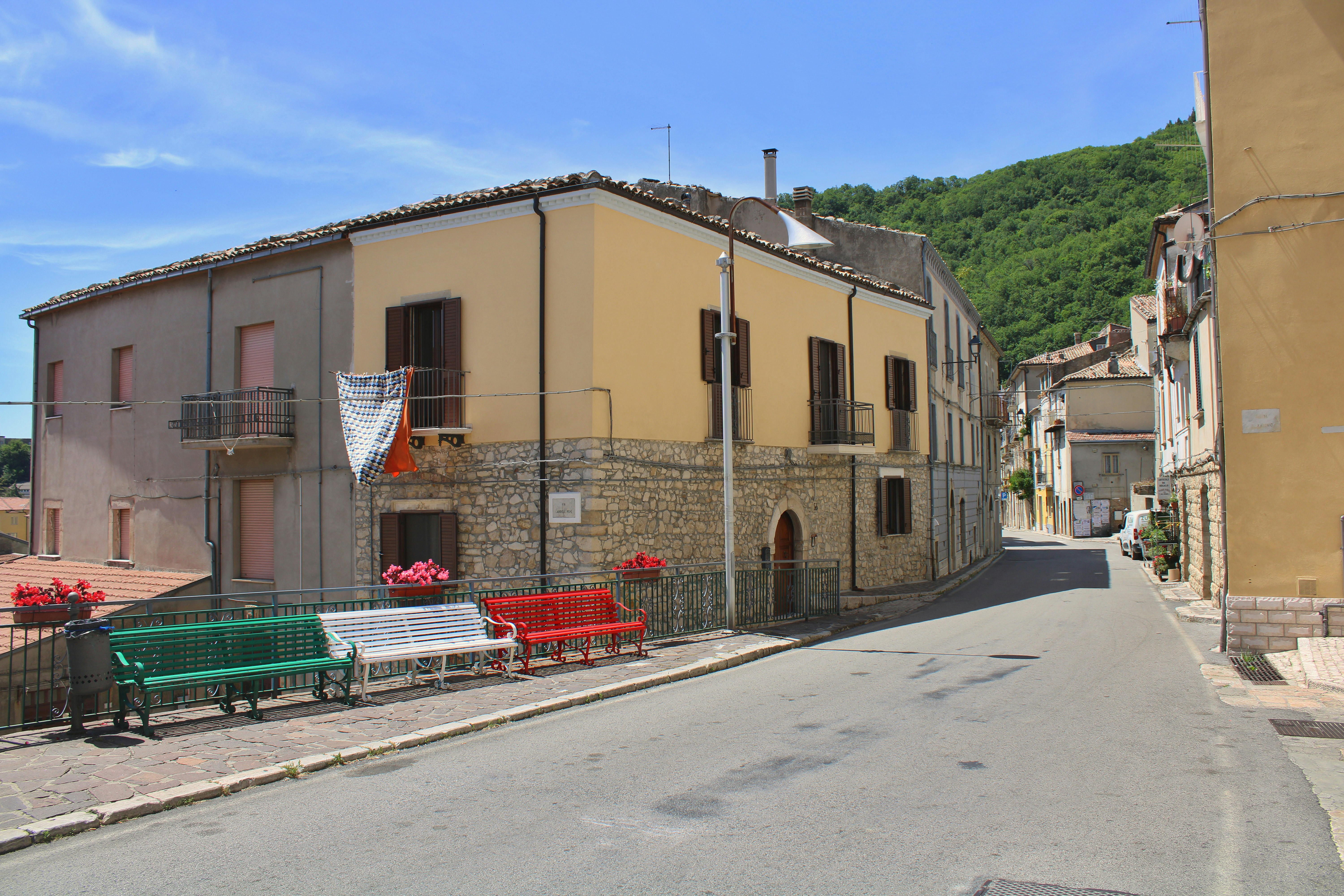 Street view of a building with colorful benches