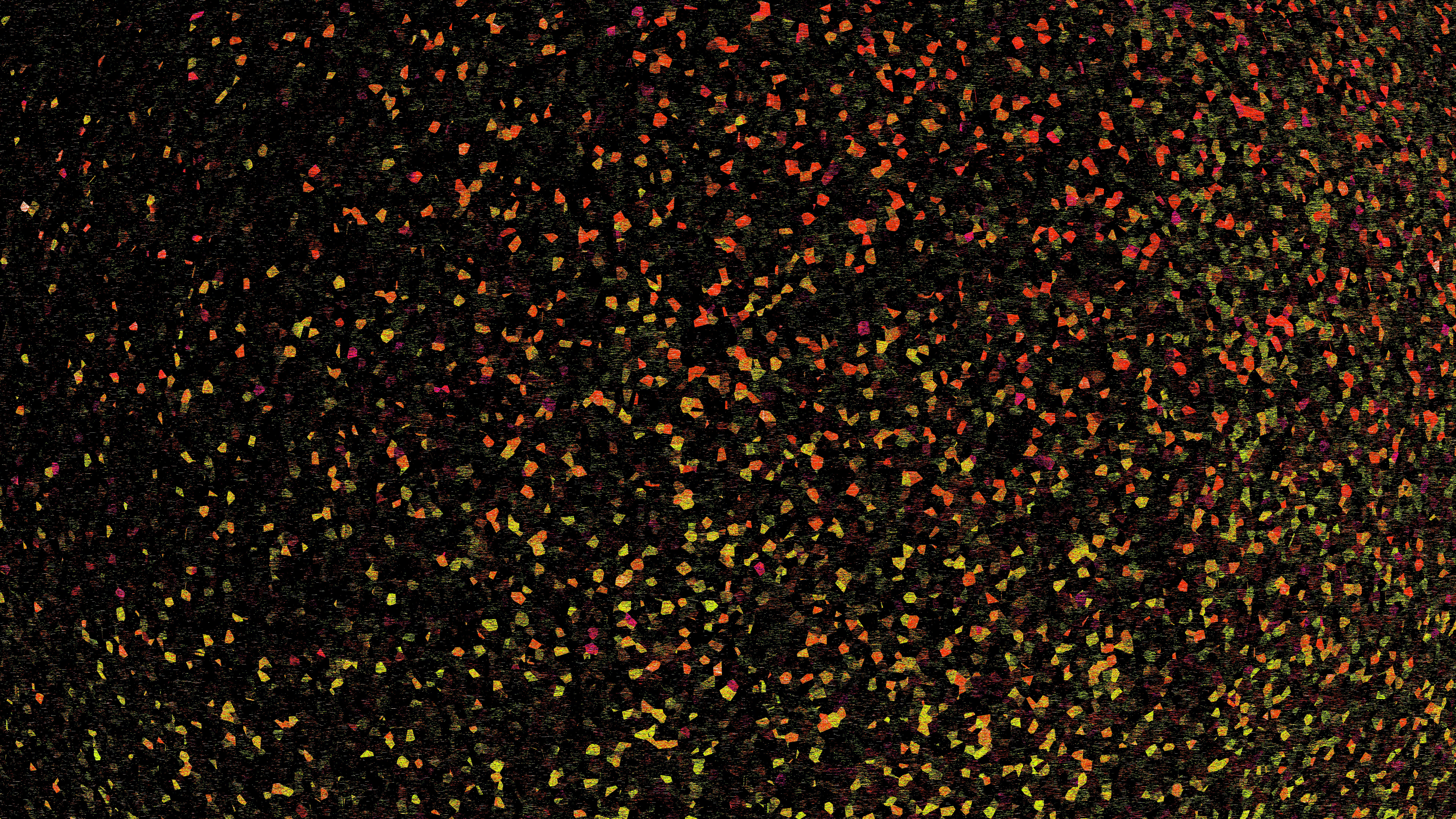 Un campo denso di piccoli fiori rosa e gialli.