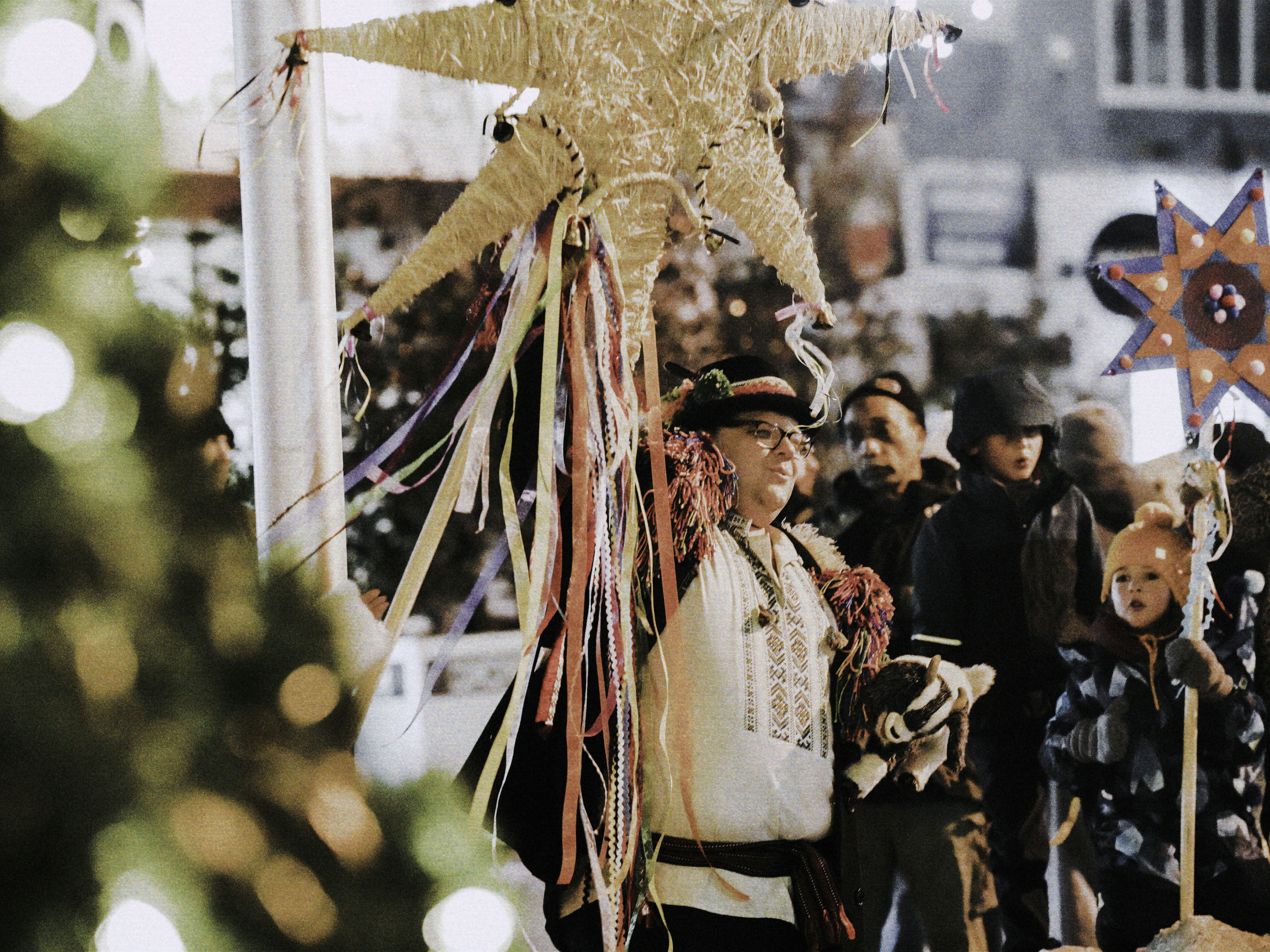 People in traditional costumes with star decorations