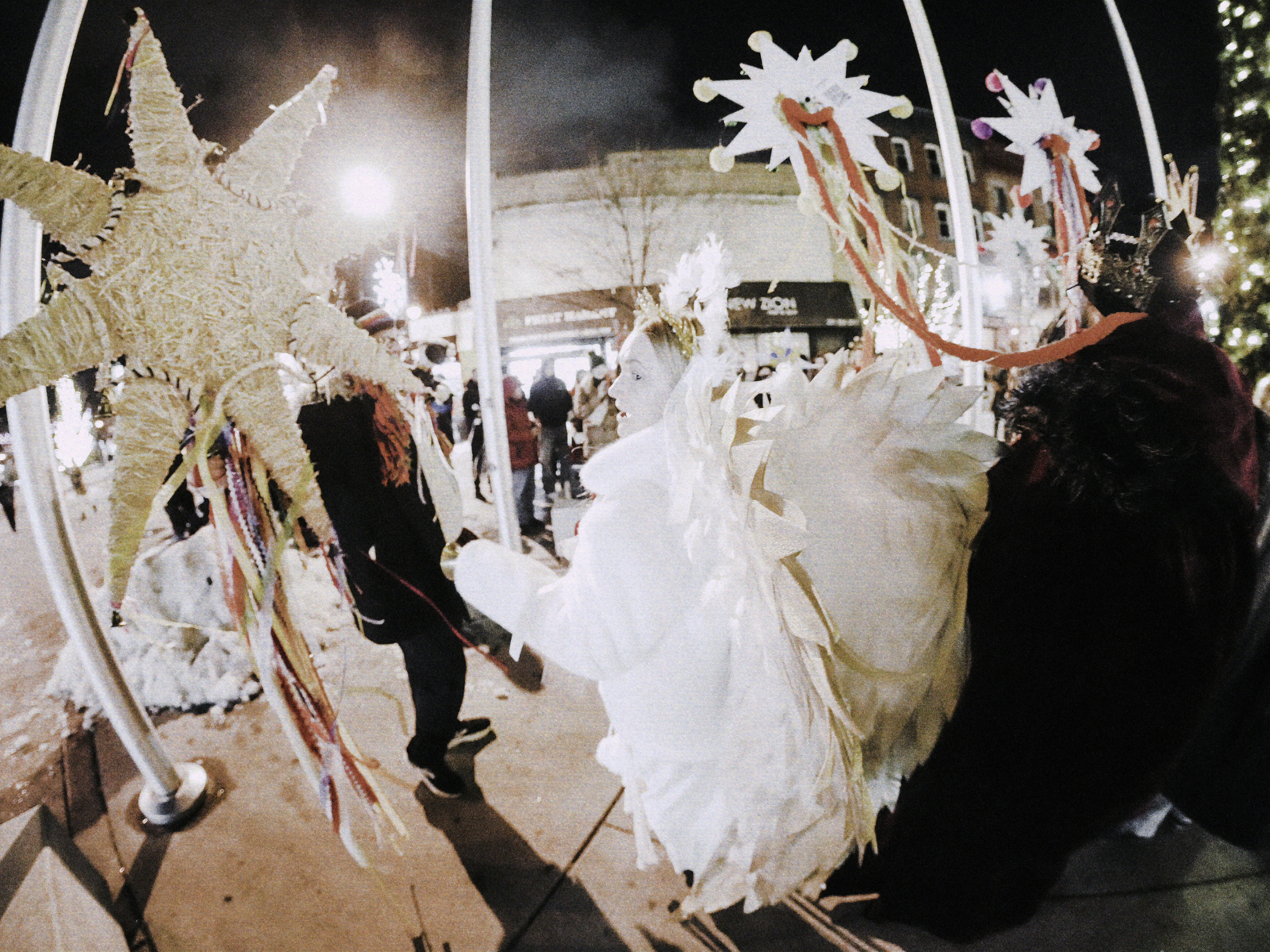 People in costumes with star decorations at night