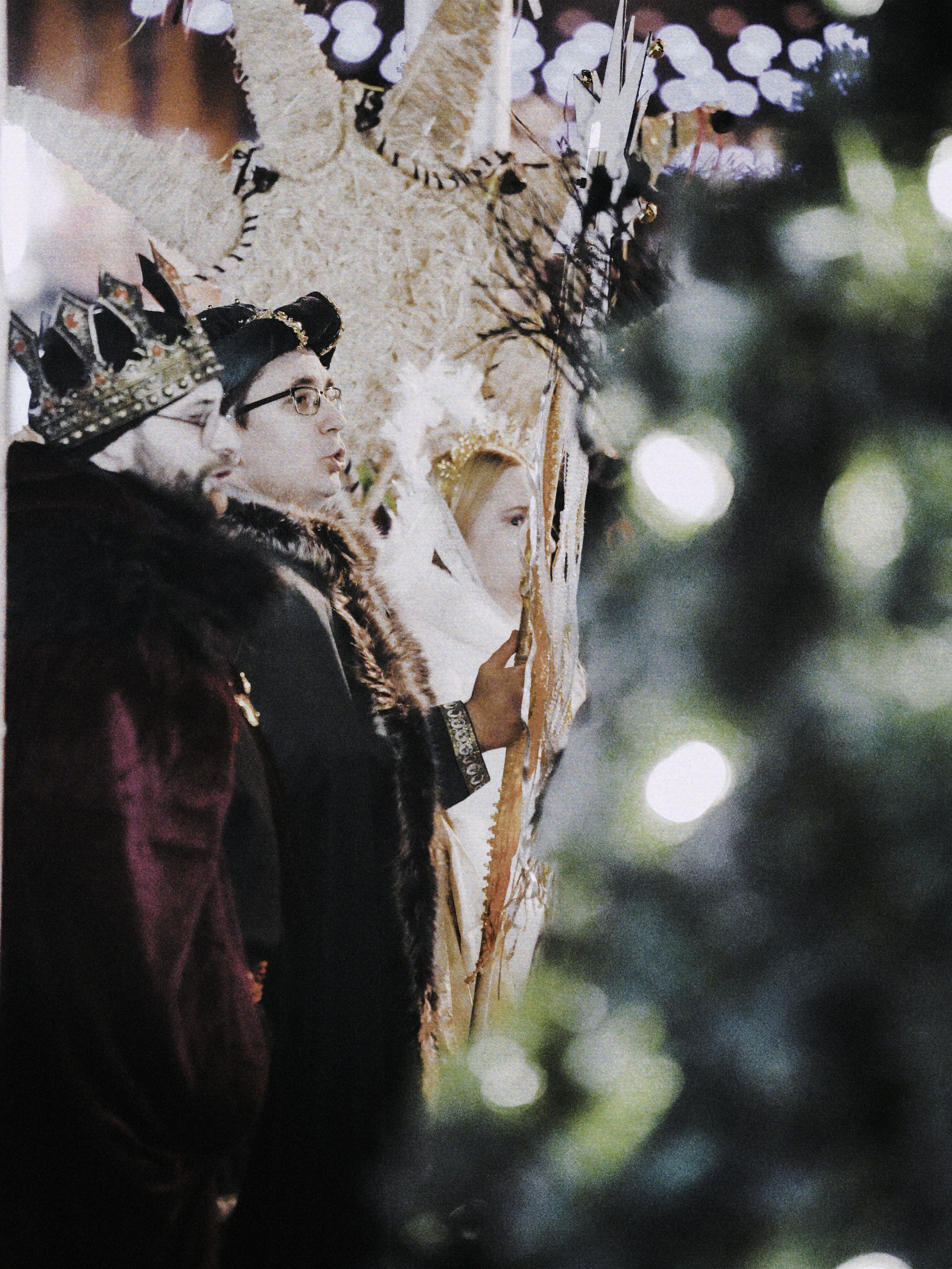 Three people in costumes with crowns and a star