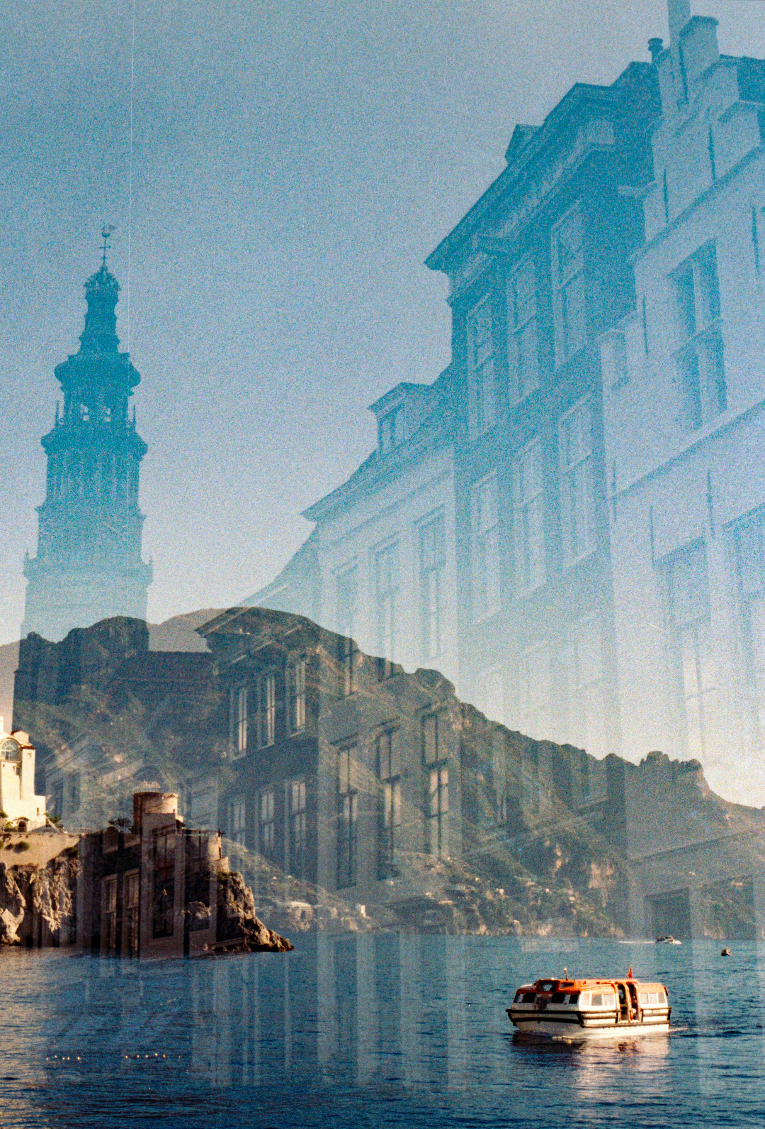 Double exposure of european buildings and a boat on water.