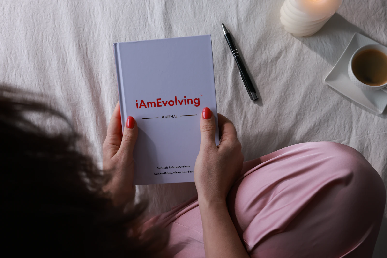 Person holding a journal while reflecting on mistakes, growth and self-compassion after a breakup.