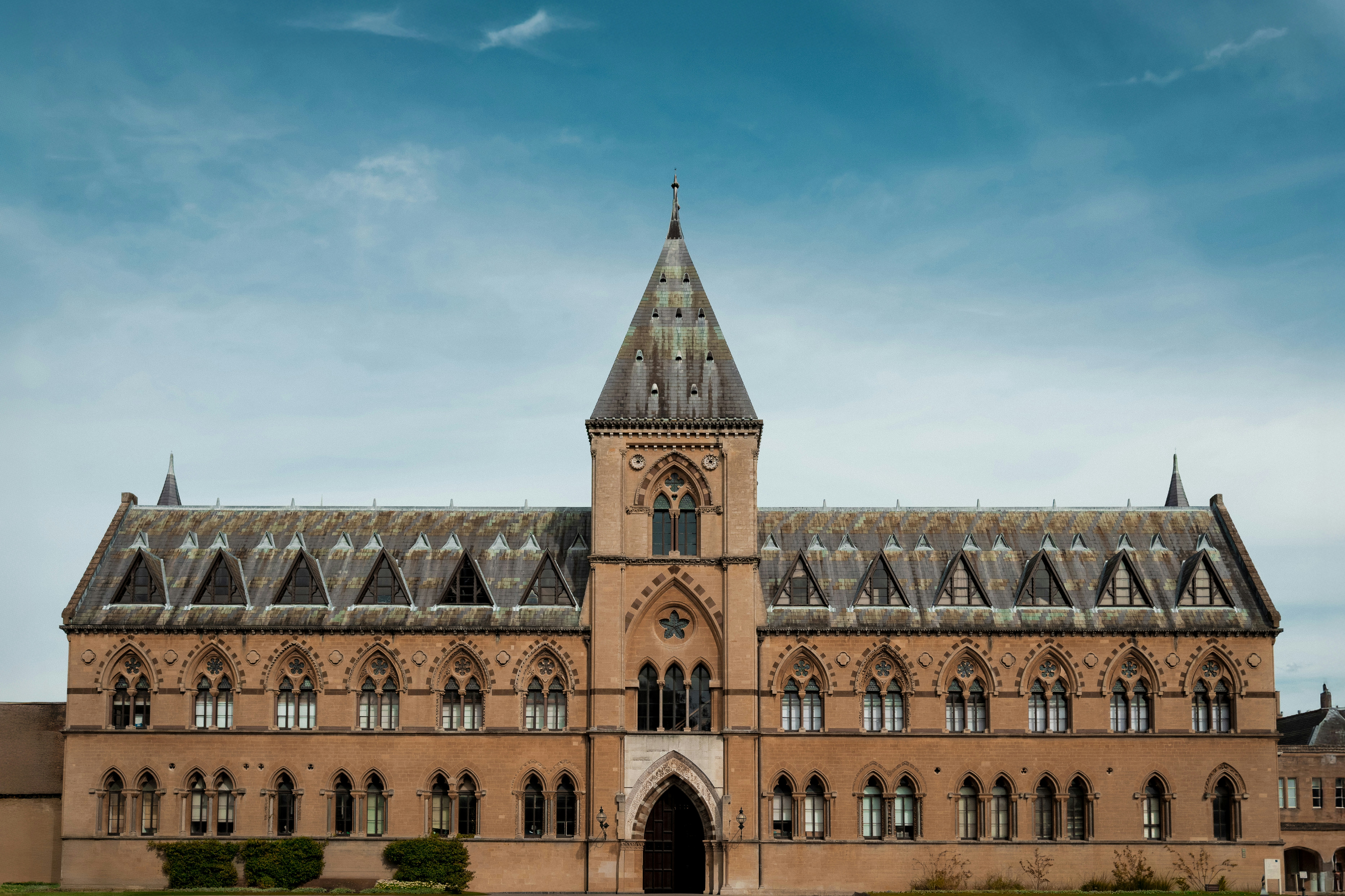 A large, ornate stone building with a tall spire.