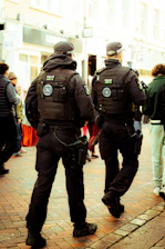 Two police officers walking down a street.