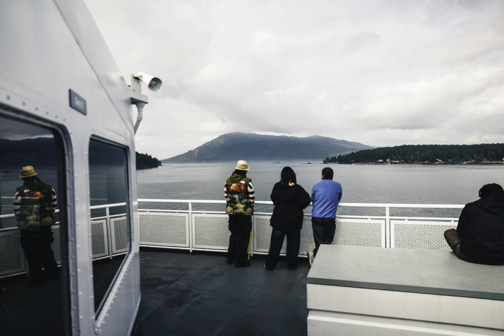 People on a ferry looking out at the water