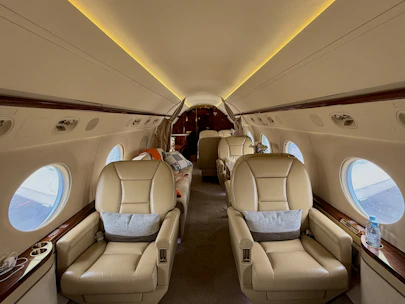 Luxurious interior of a private jet with comfortable seating.